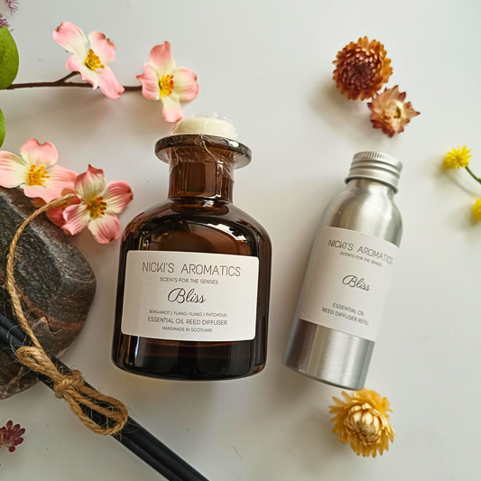 Bliss natural essential oil reed diffuser in an apothecary style amber glass bottle with a 100ml refill in an aluminium bottle