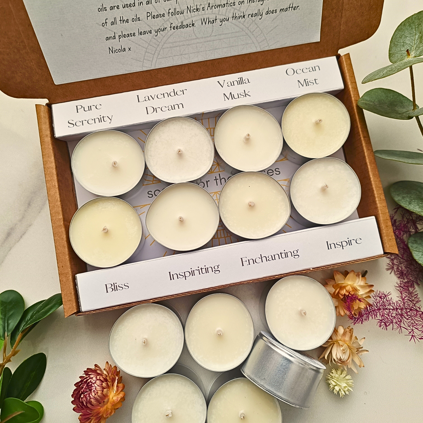 An open box of 8 clearly labelled chunky tealights next to 6 tea lights