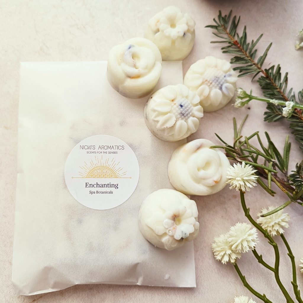 Six Enchanting wax melts on a glassine bag of wax melts
