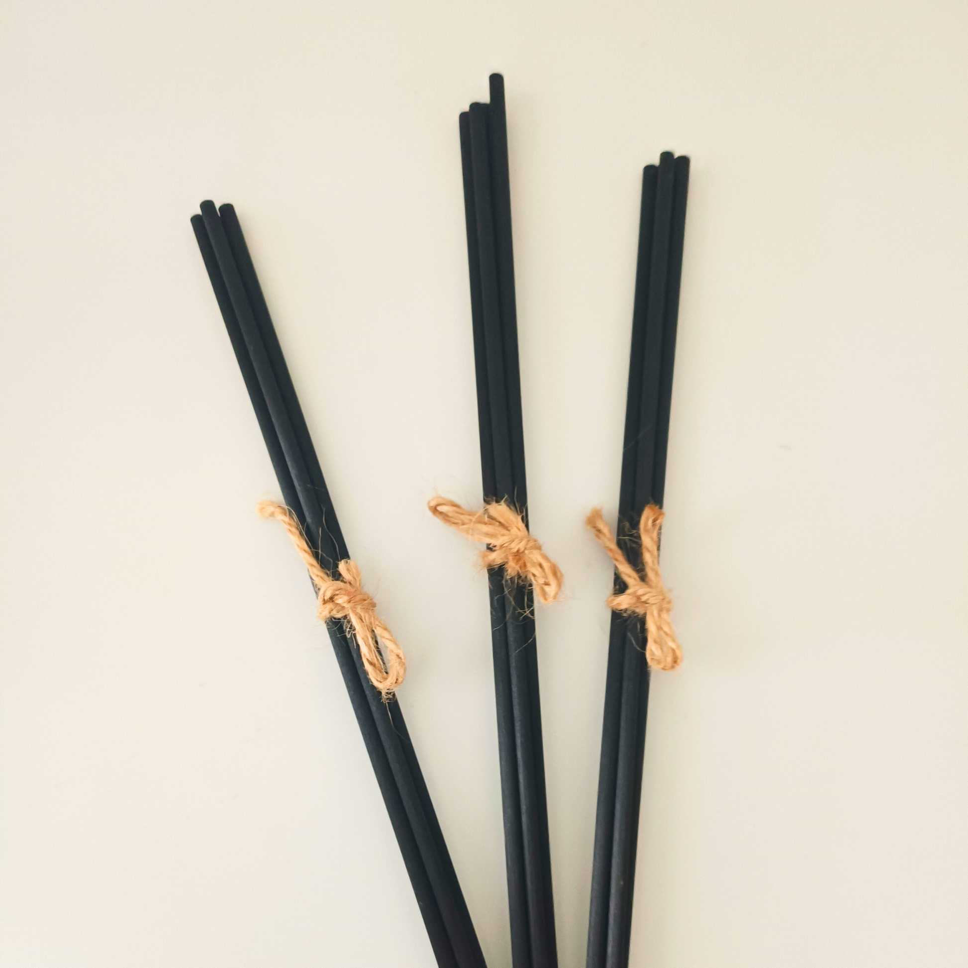 three sets of four black fibre reed diffuser sticks