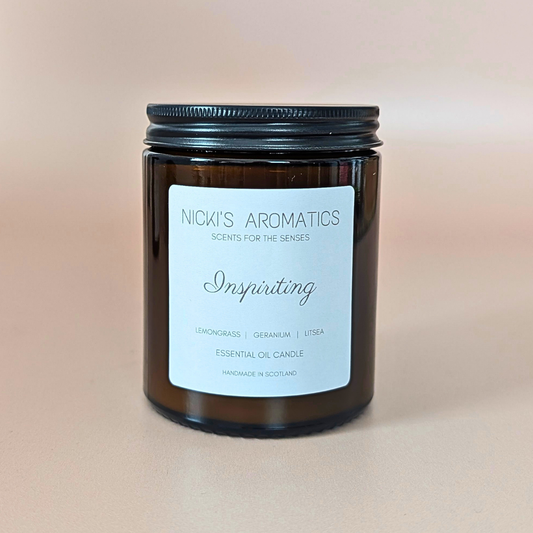 Inspiriting essential oil candle with lemongrass, geranium and litsea in an amber glass jar