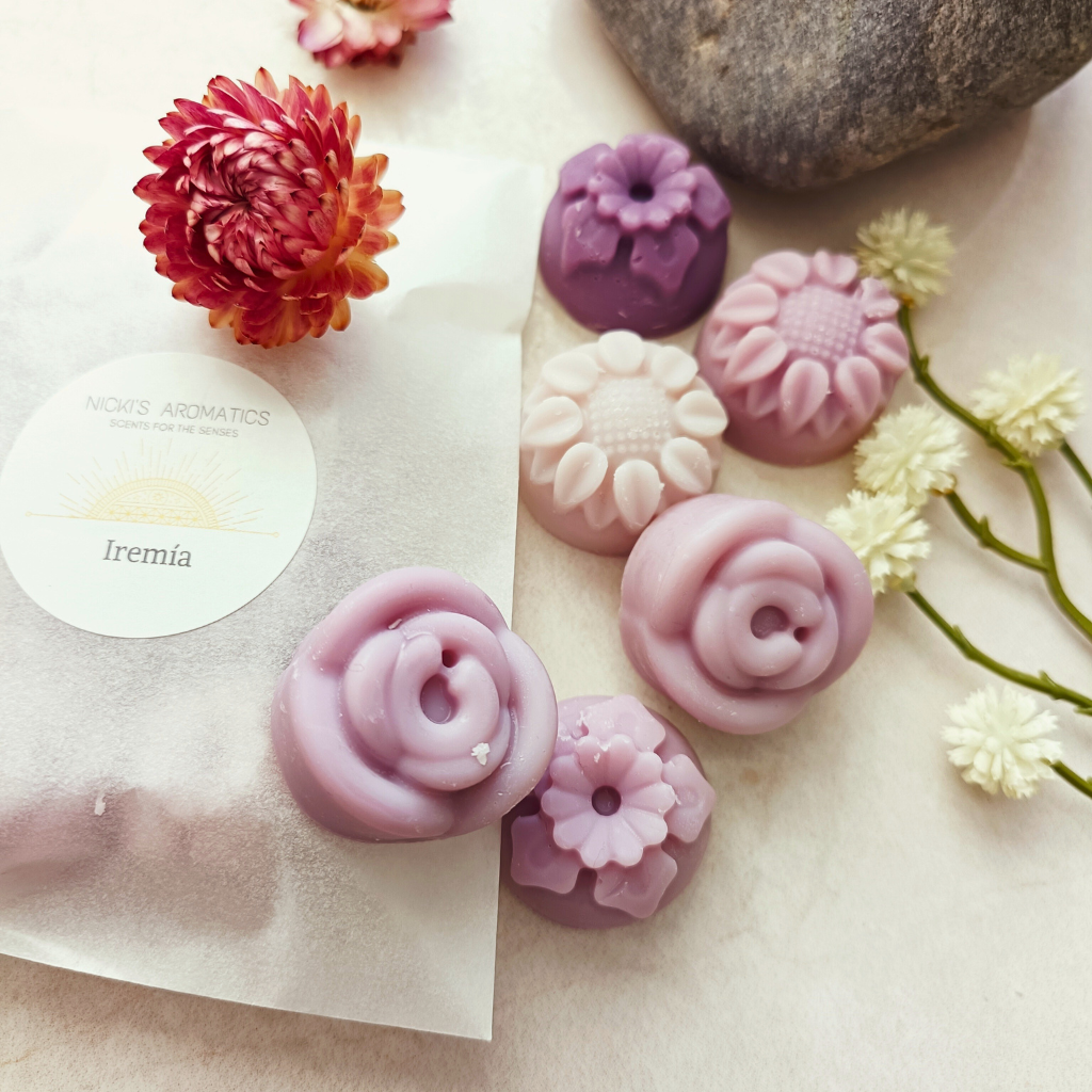 6 Iremia flower-shaped wax melts next to a glassine bag containing wax melts