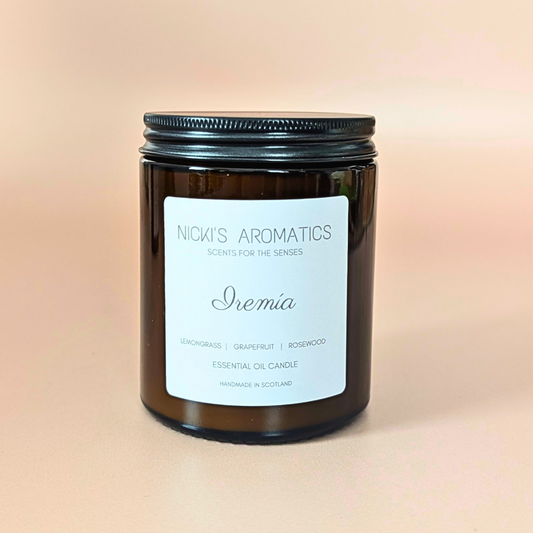 iremia essential oil candle with lemongrass, grapefruit and rosewood in an amber glass jar