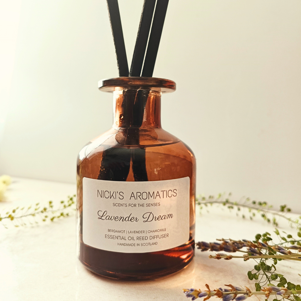 natural essential oil reed diffuser in an apothecary style amber glass with black fibre reeds