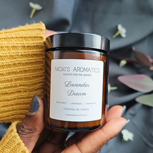 Lavender Dream essential oil candle being held in a pair of hands