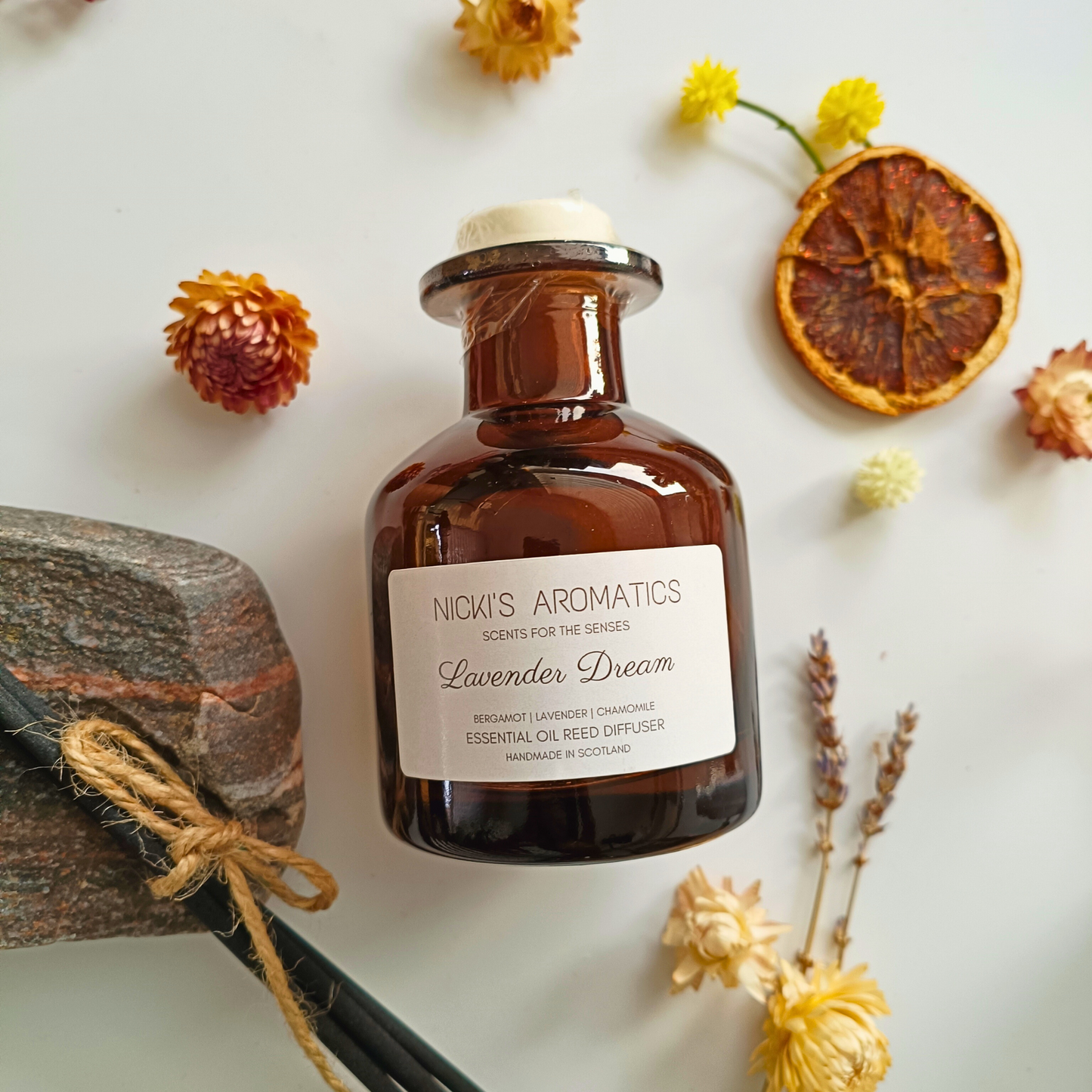 natural essential oil reed diffuser in an apothecary style amber glass bottle