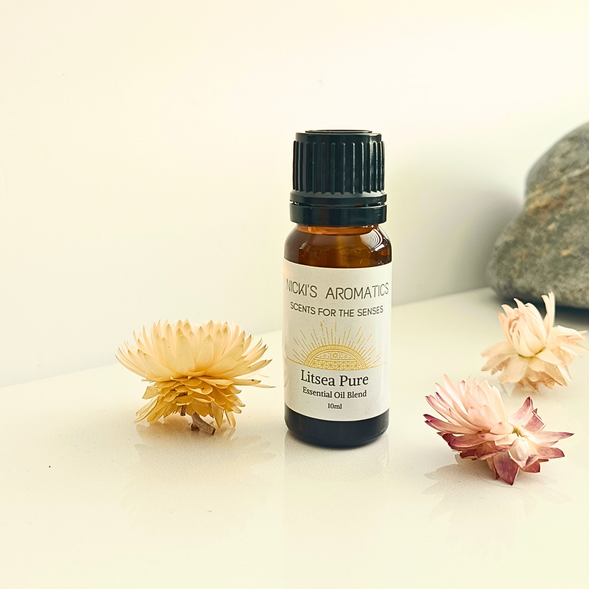 A 10ml amber glass bottle of Litsea Pure essential oil blend