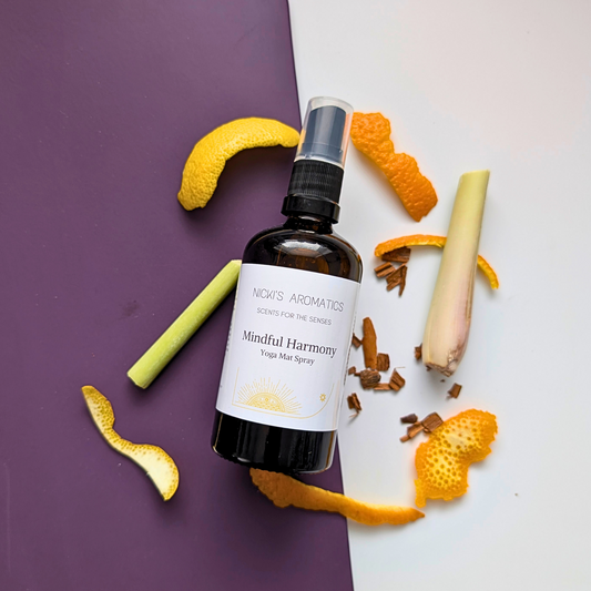 natural yoga mat spray in an amber glass bottle surrounded by its ingredients