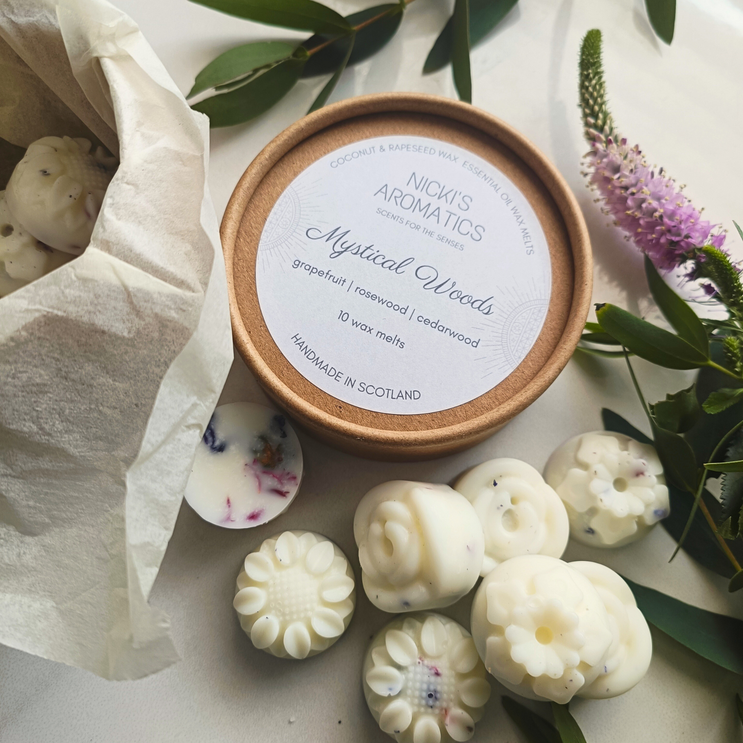 an open kraft tub with flower-shaped essential oil wax melts