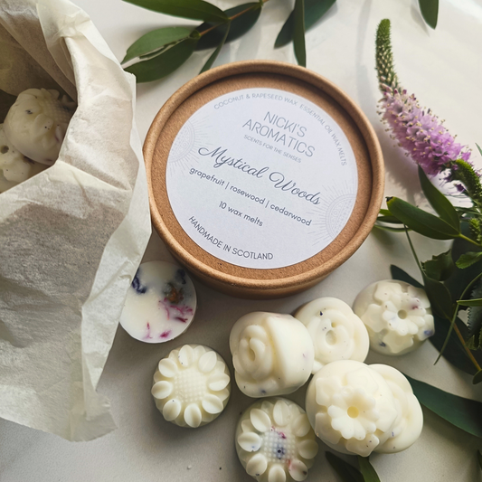 an open kraft tub with flower-shaped essential oil wax melts