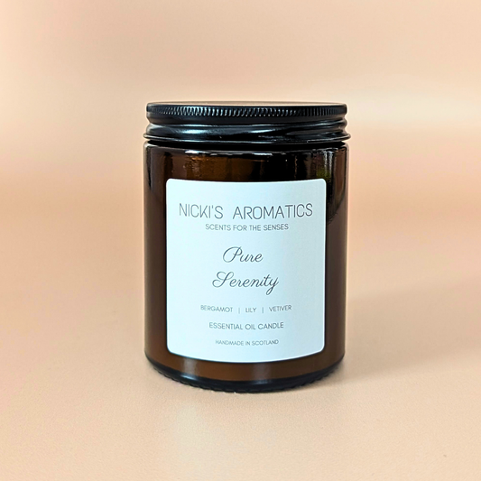 Pure Serenity essential oil candle with bergamot, lily and vetiver in an amber glass jar