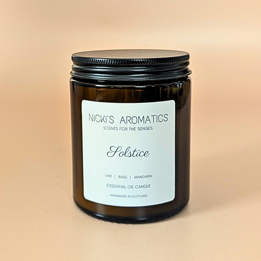 Solstice essential oil candle with lime, mandarin and basil in an amber glass jar