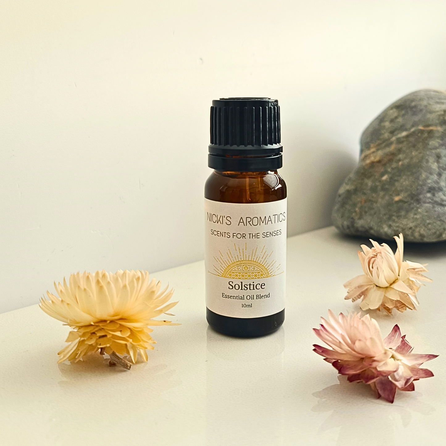 A 10ml amber glass bottle of Solstice lime basil and mandarin essential oil blend