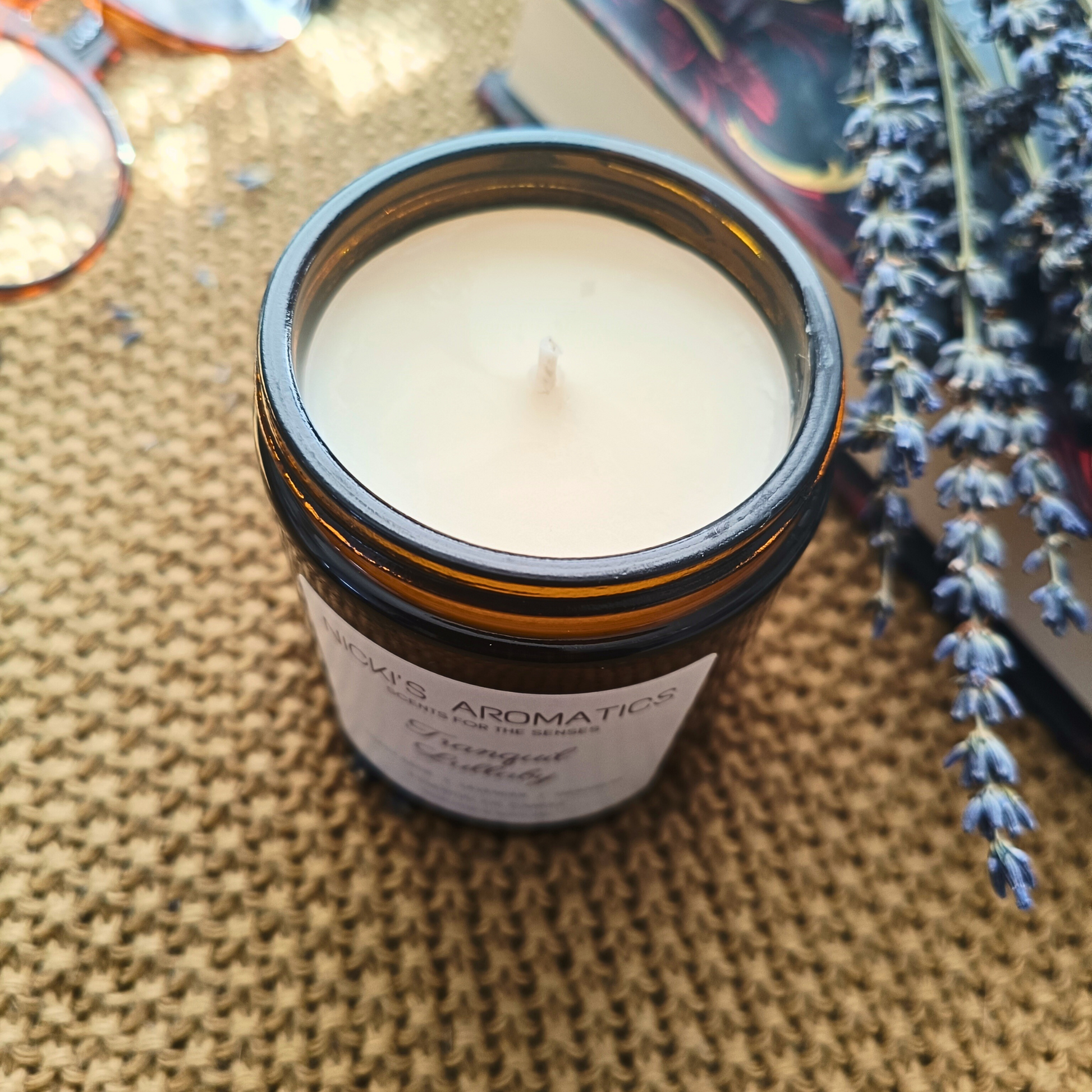 Tranquil lullaby essential oil candle showing the open amber glass jar
