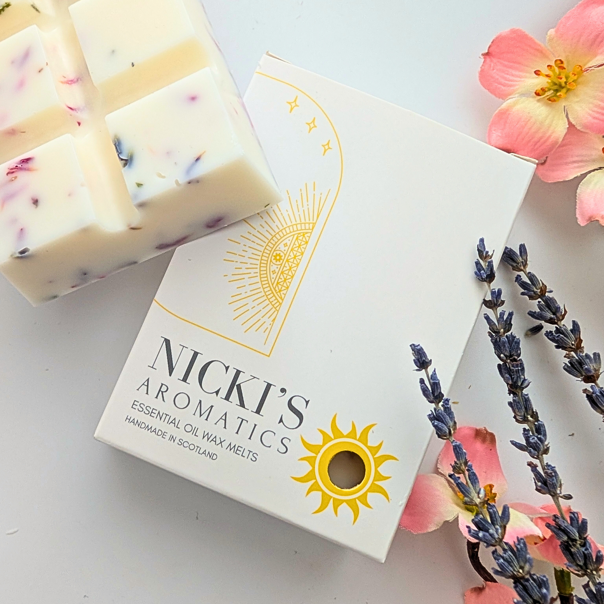 A box containing a chunky essential oil wax melt bar with a chunky wax melt bar to the left