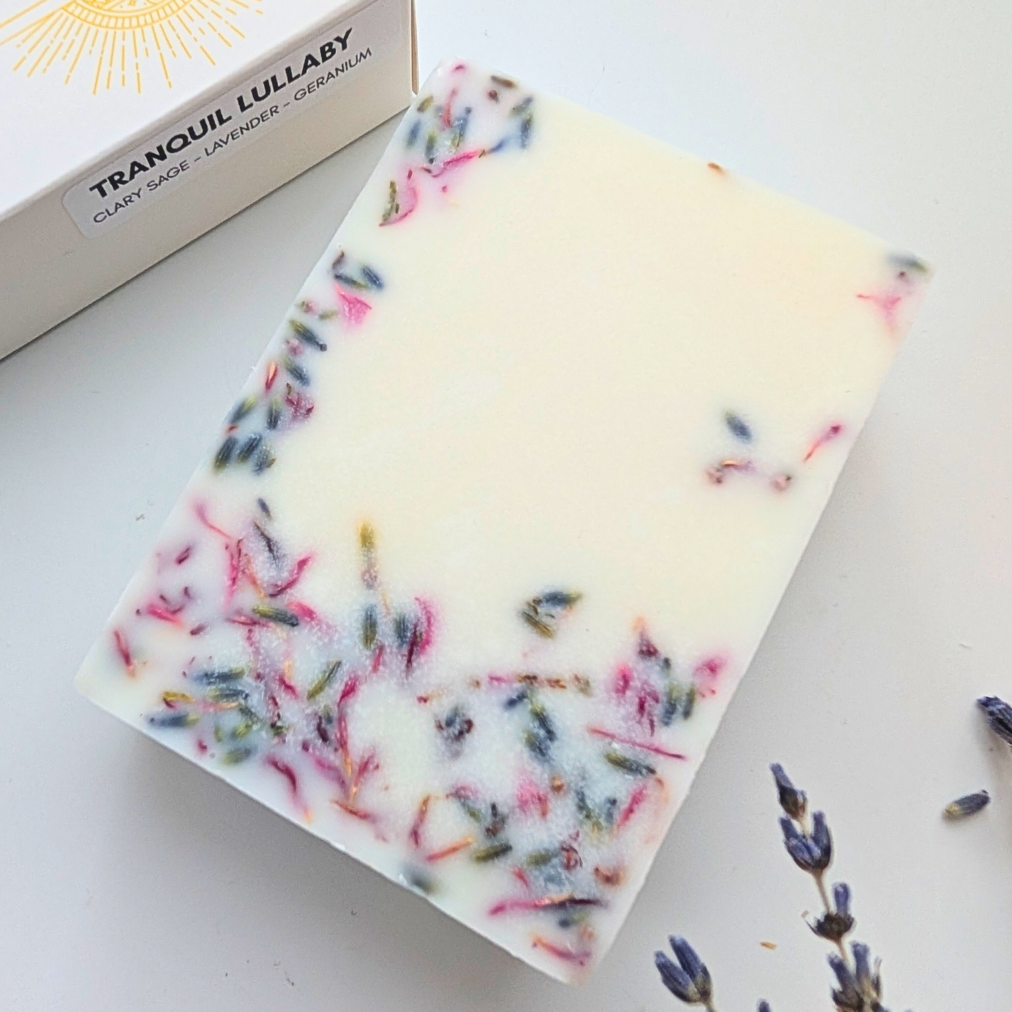 A chunky essential oil wax melt bar showing the dried flowers in the bar