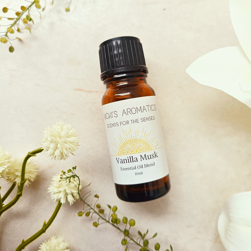 One 10ml bottle of Vanilla Musk essential oil blend next to some flowers