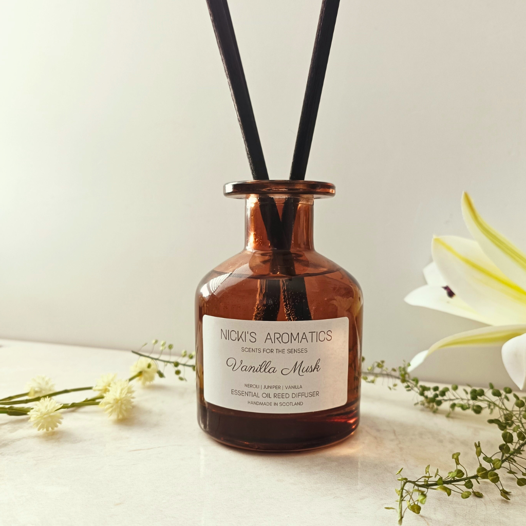 natural essential oil reed diffuser in an amber glass apothecary style bottle with black fibre reeds