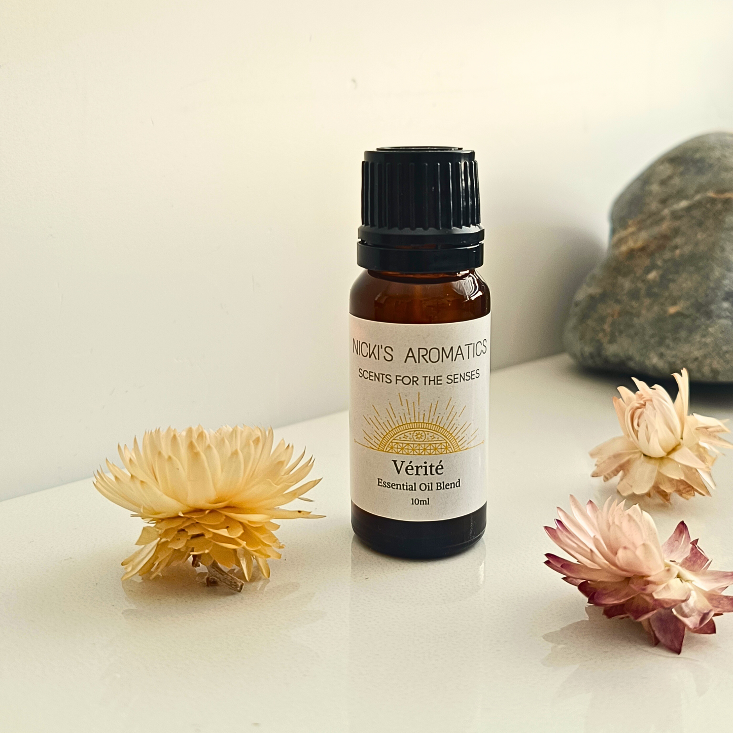 An 10ml amber glass bottle of Verite essential oil blend