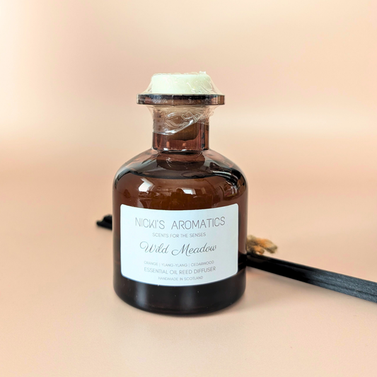 Wild Meadow essential oil reed diffuser with orange, ylang-ylang and cedarwood and black fibre reeds