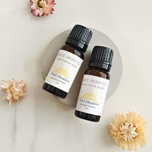 Two 10ml amber glass bottles of Wild Meadow essential oil blend