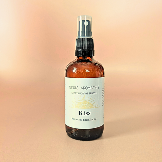 Bliss natural room and linen spray with bergamot, ylang-ylang and gingerlily in an amber glass bottle