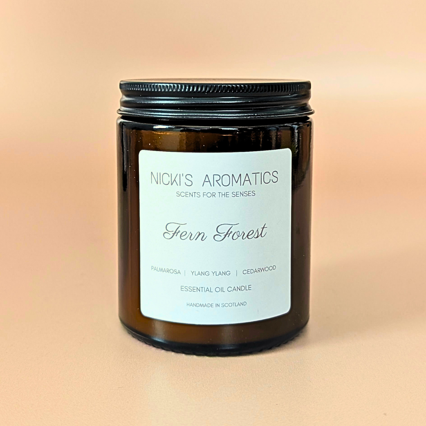 Fern Forest essential oil candle with palmarosa, ylang-ylang and cedarwood in an amber glass jar