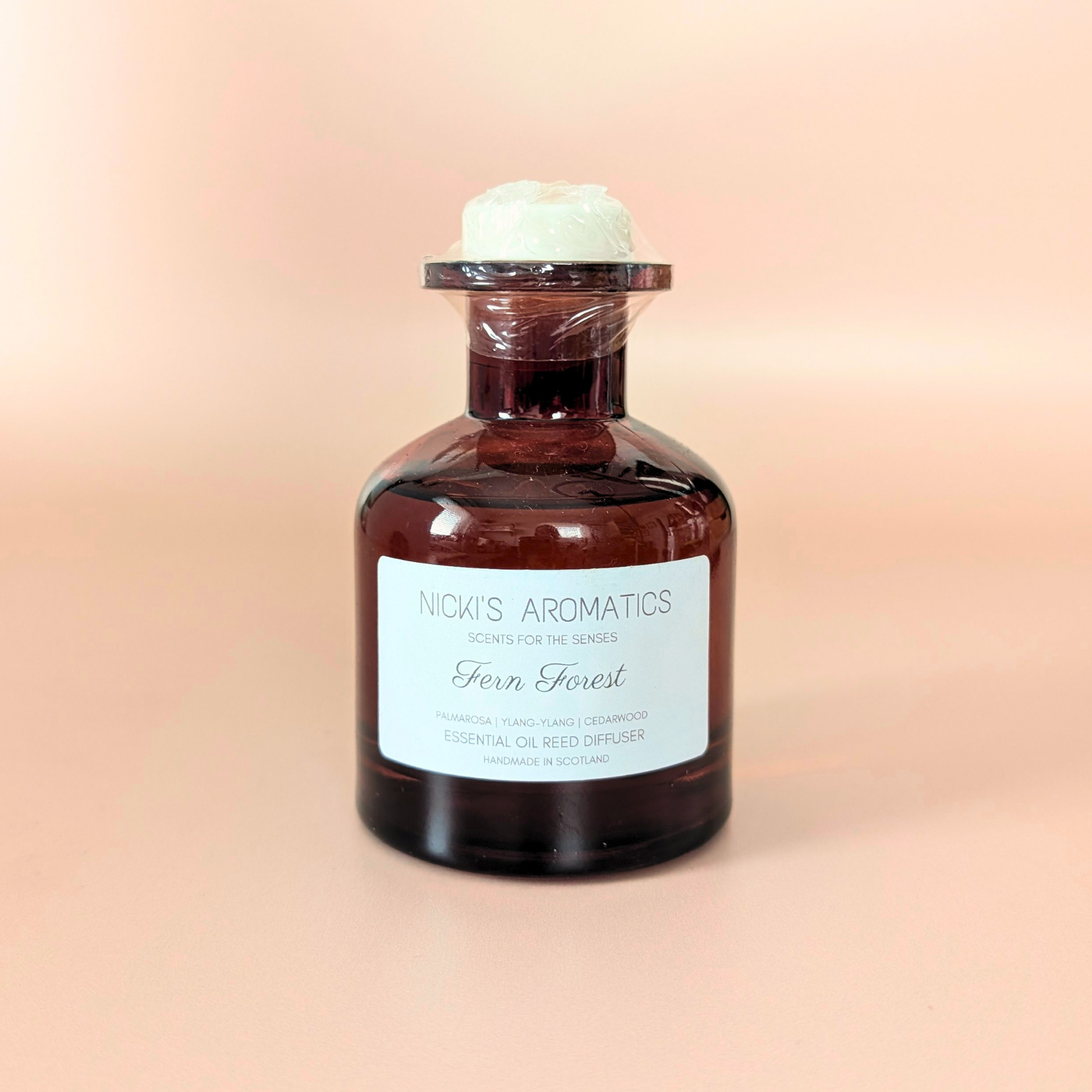 Bliss essential oil reed diffuser with palmarosa, ylang-ylang and cedarwood in an amber glass bottle