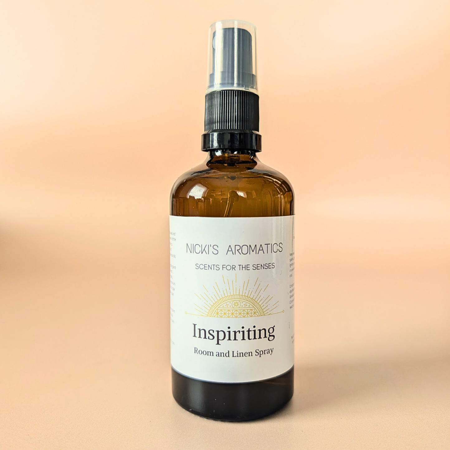 Inspiriting natural room and linen spray with lemongrass, litsea and geranium in an amber glass bottle