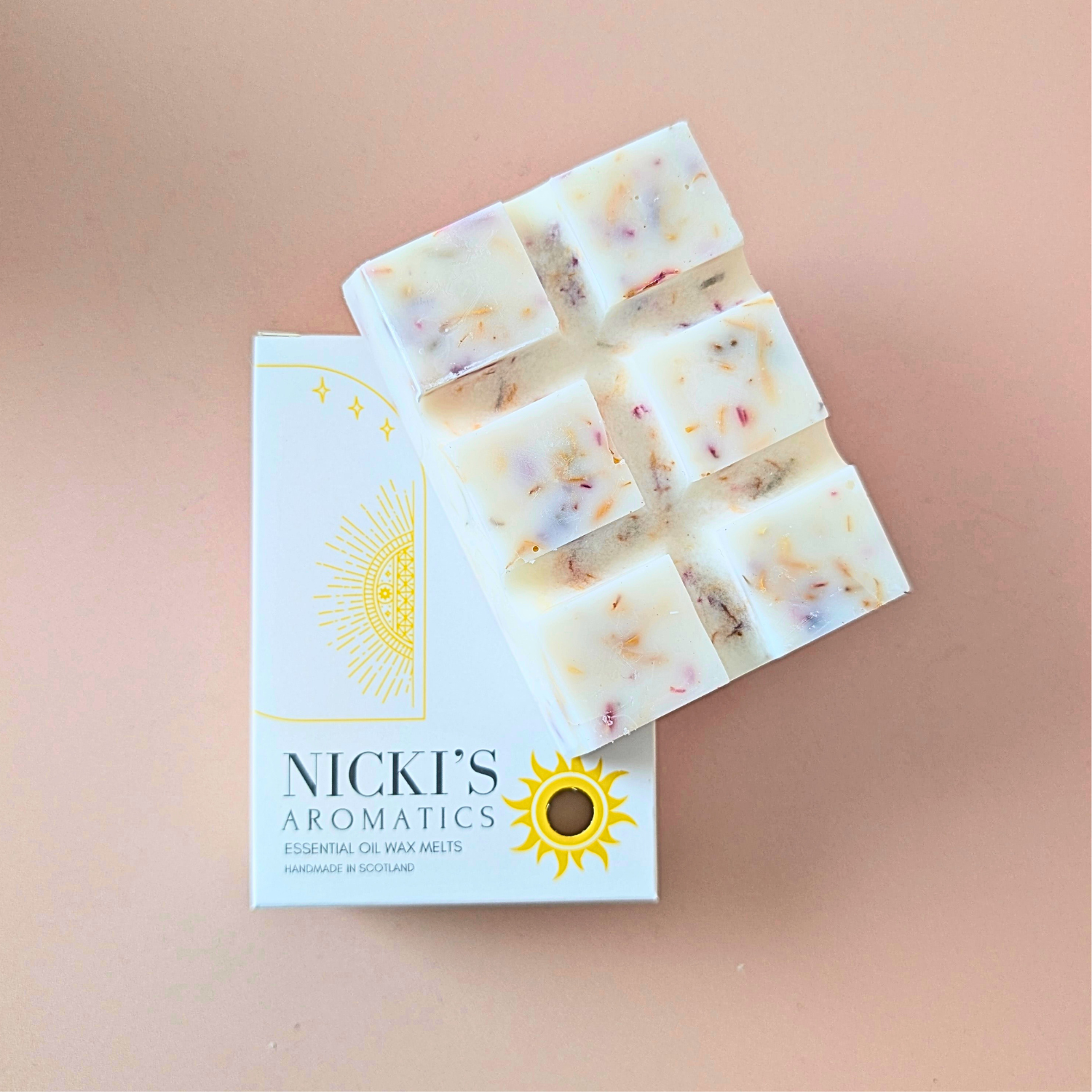 Inspiriting essential oil wax melt bar with botanical details in Nicki’s Aromatics packaging