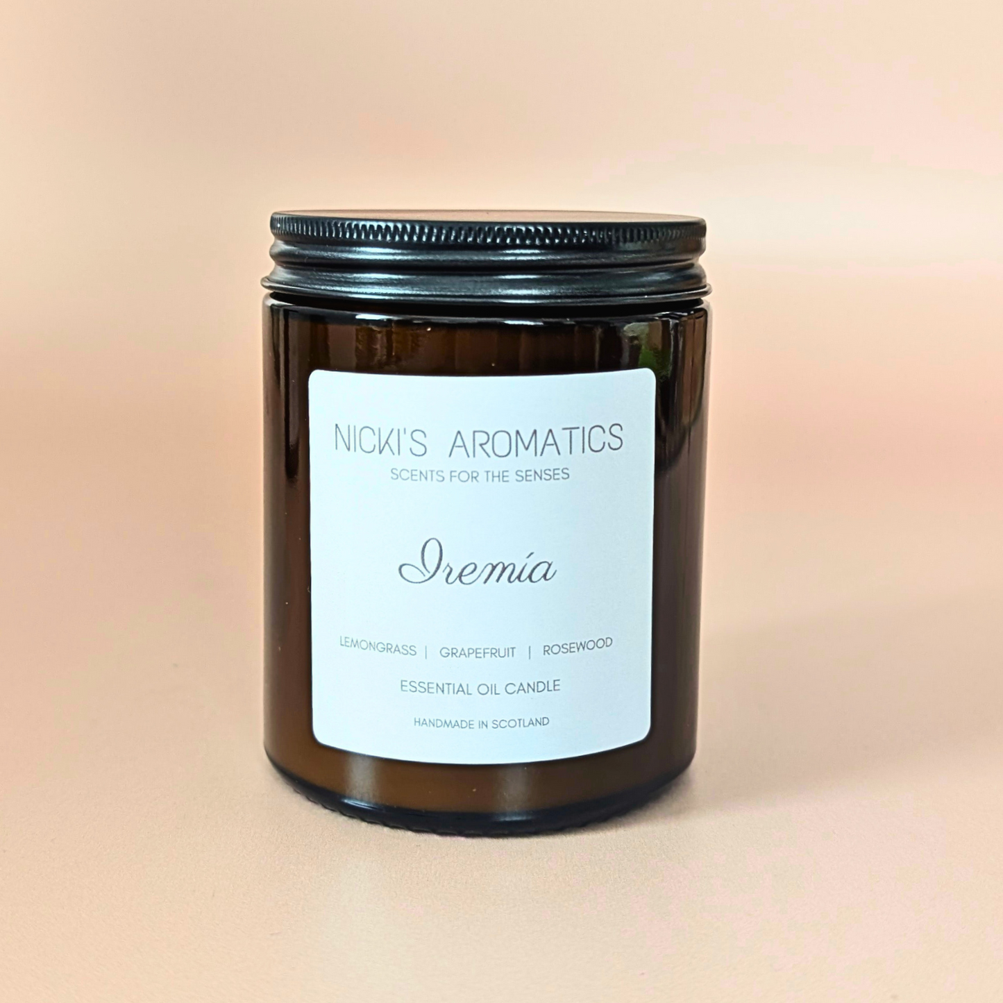 iremia essential oil candle with lemongrass, grapefruit and rosewood in an amber glass jar