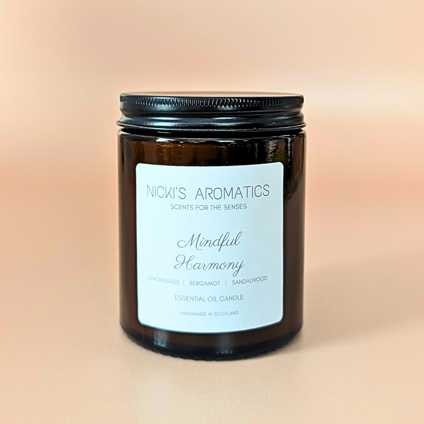 Mindful Harmony essential oil candle with lemongrass, Sandalwood and bergamot in an amber glass jar