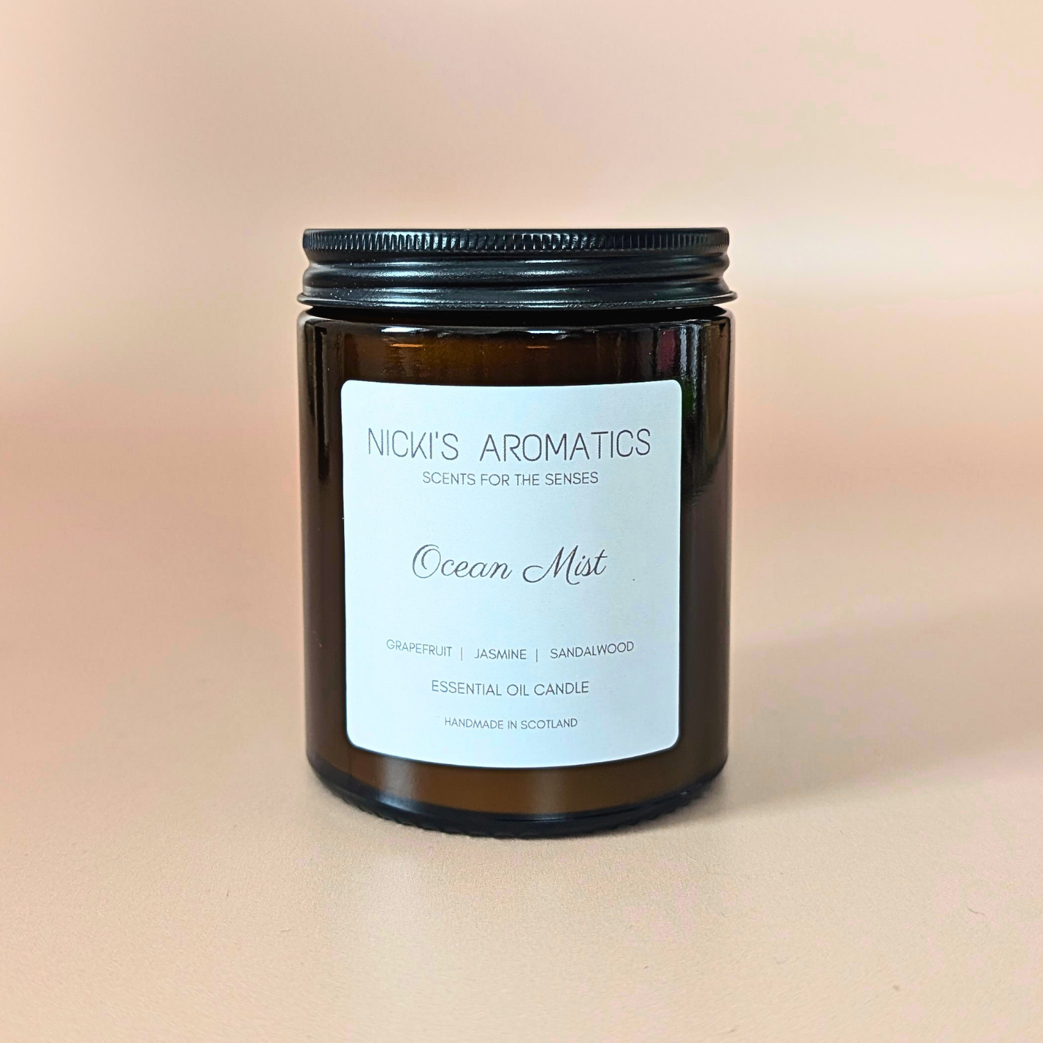 Ocean Mist essential oil candle with grapefruit, jasmine and sandalwood in an amber glass jar