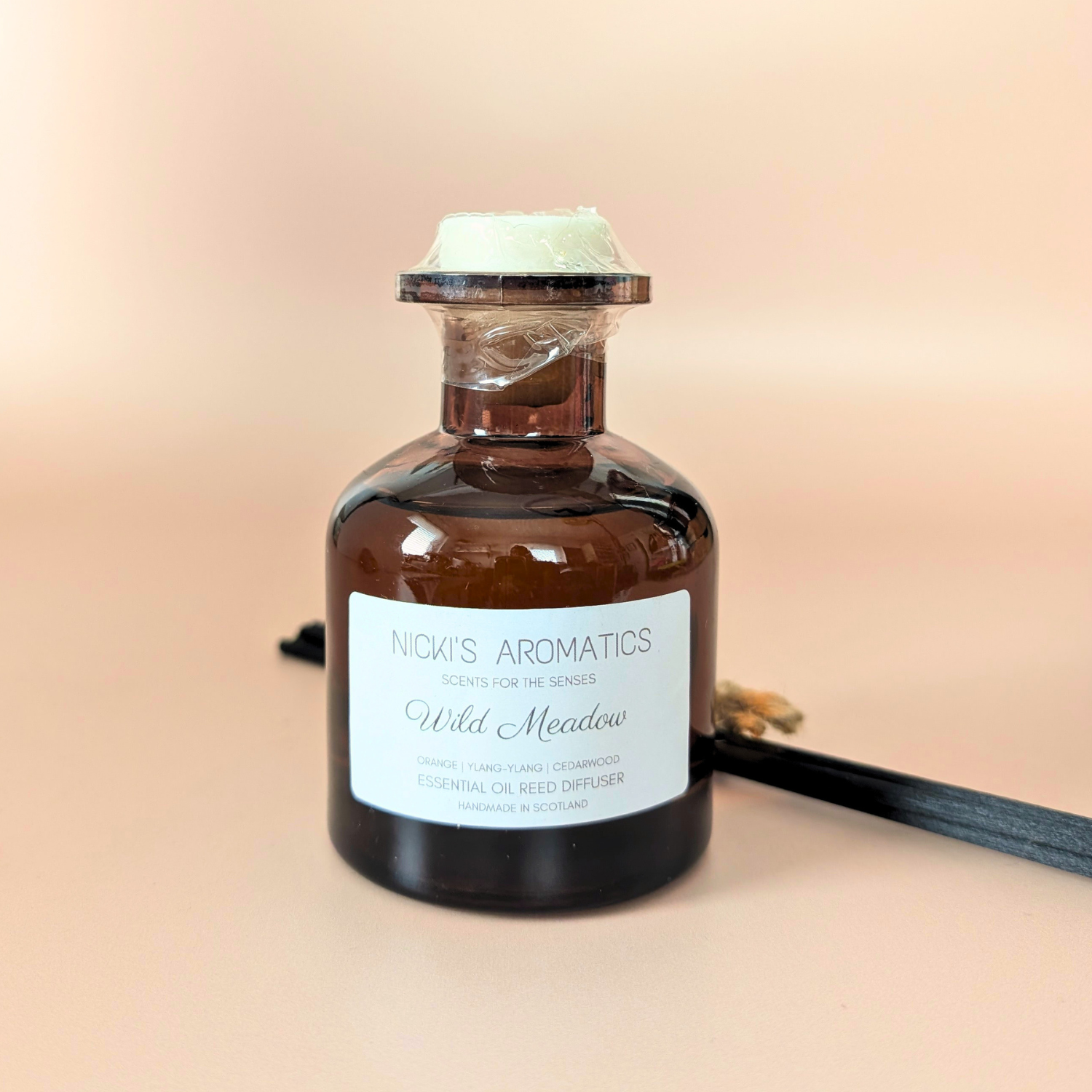 Wild Meadow essential oil reed diffuser with orange, ylang-ylang and cedarwood and black fibre reeds