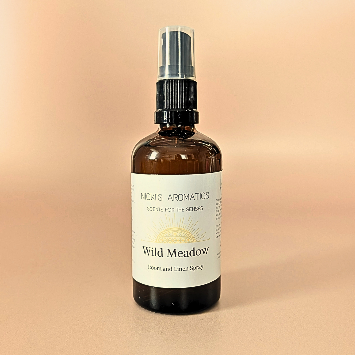 Wild Meadow natural room and linen spray with sweet orange, ylang-ylang and cedarwood in an amber glass bottle