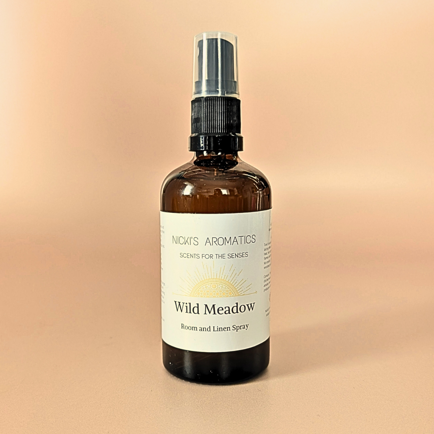 Wild Meadow natural room and linen spray with sweet orange, ylang-ylang and cedarwood in an amber glass bottle
